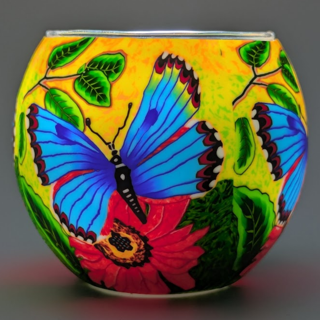 Decorative glass globe with colorful butterfly and floral design on a yellow background