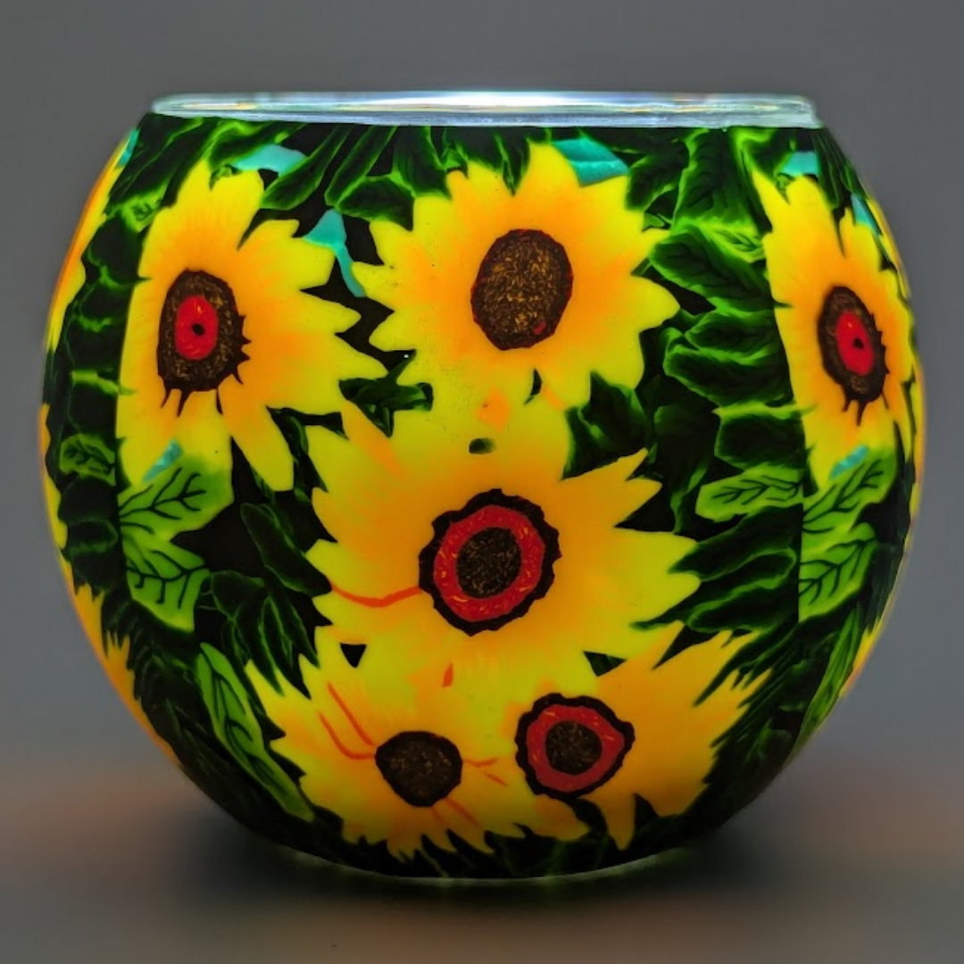 Decorative glass globe with sunflower pattern on a dark background